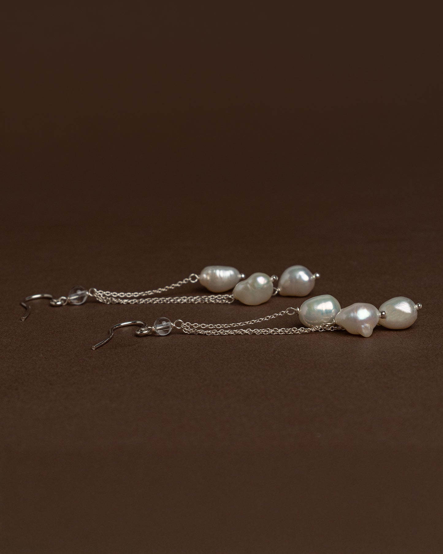 Cascade earrings with sterling silver chains and large baroque pearls. Unique handmade jewelry perfect for bridal wear or minimalist luxury looks.