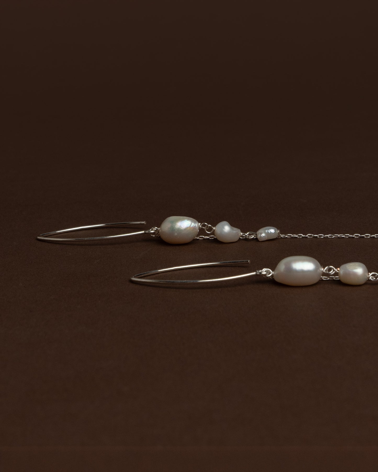 Elegant long earrings with baroque freshwater pearls and silver chains. Handmade and unique, ideal for brides and special occasions.