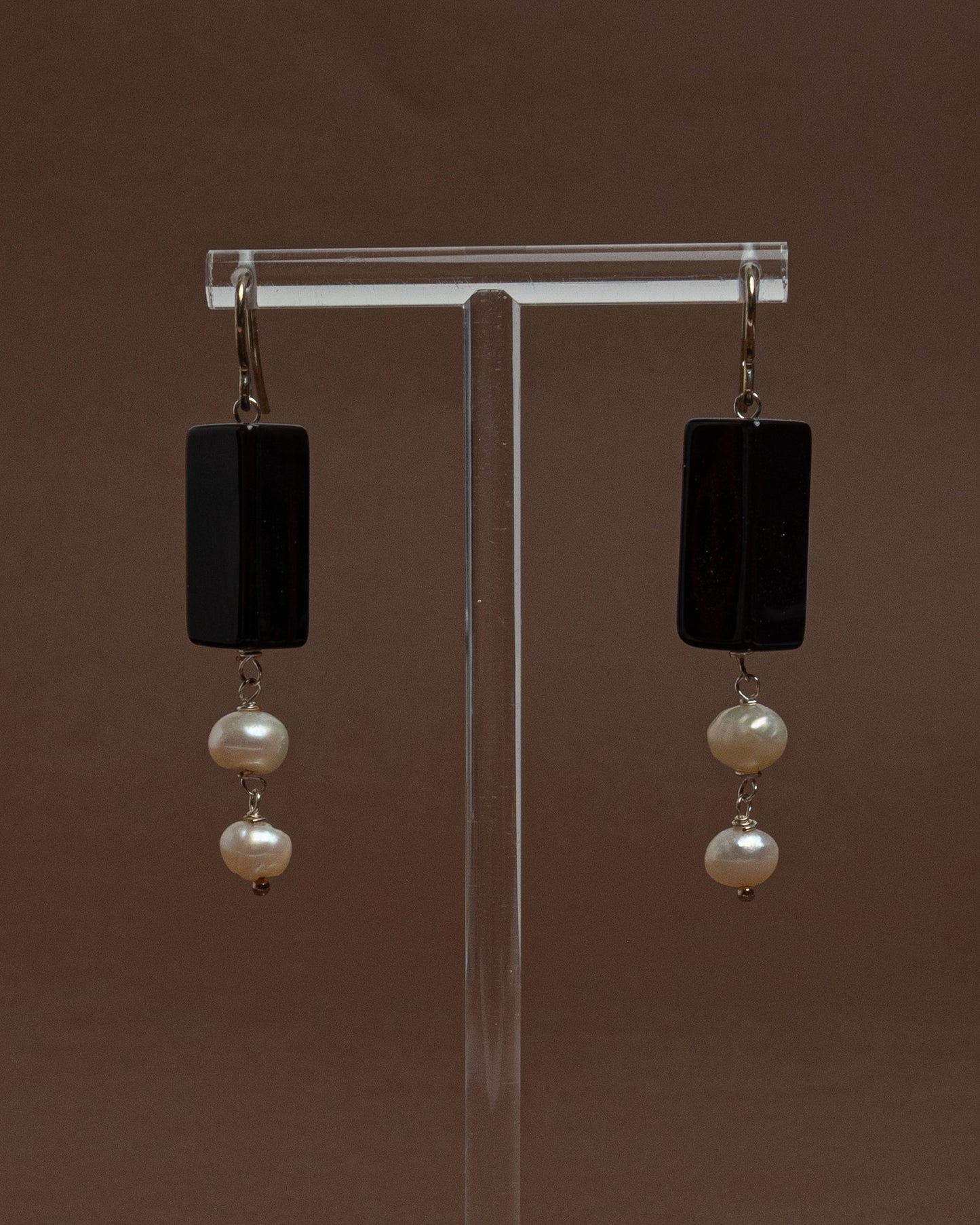 Minimalist earrings with baroque pearls and black agate. Handmade sterling silver drop earrings for modern elegance and everyday sophistication.