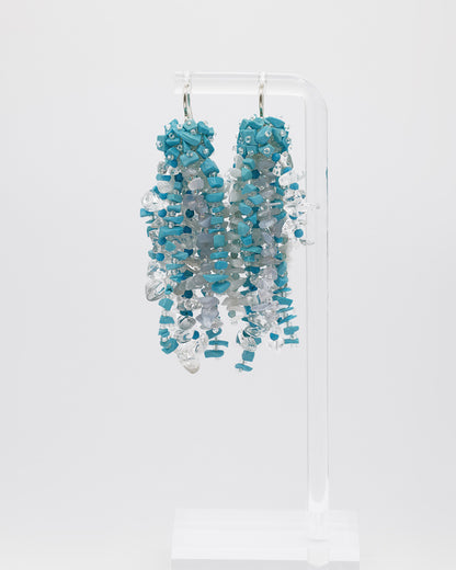 Mixed gemstones earrings featuring topaz, apatite, turkenite, chalcedony, and quartz stones with silver hooks, 8 cm in length.