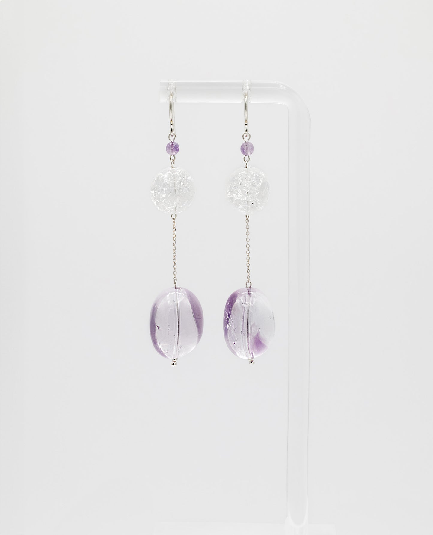 Elegant chain earrings featuring shimmering Crackle Quartz and a deep purple oval Amethyst stone, suspended from silver chains with hooks.