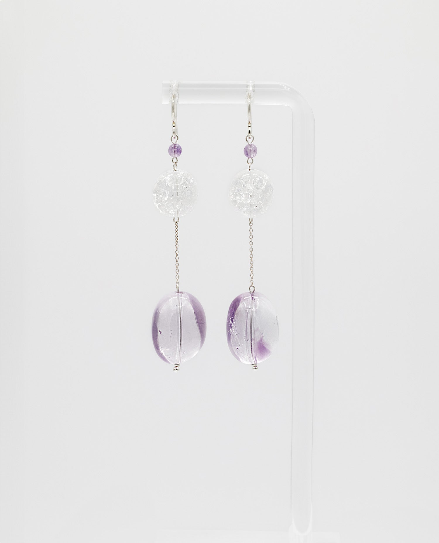 Elegant chain earrings featuring shimmering Crackle Quartz and a deep purple oval Amethyst stone, suspended from silver chains with hooks.