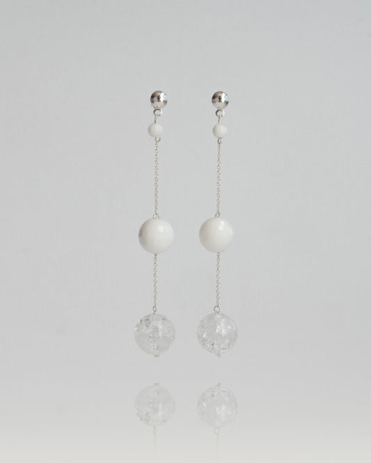 Delicate chain earrings featuring luminous Clear Quartz and soft White Coral, suspended from silver chains with hooks, 8 cm in length.