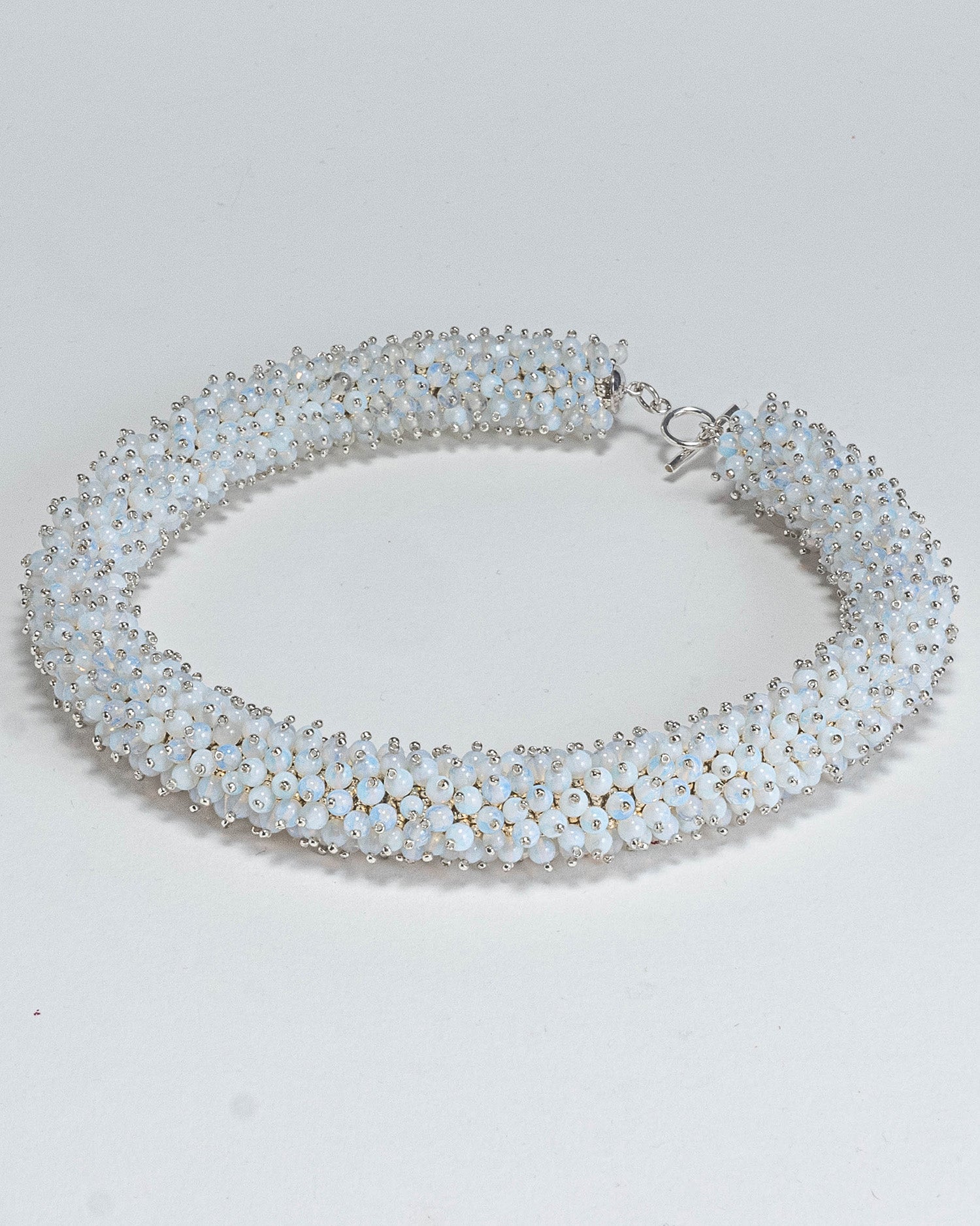 Radiant opalite necklace featuring opalescent beads in a bold rope design with a silver T-bar clasp, 45 cm in length, perfect for haute couture styling.