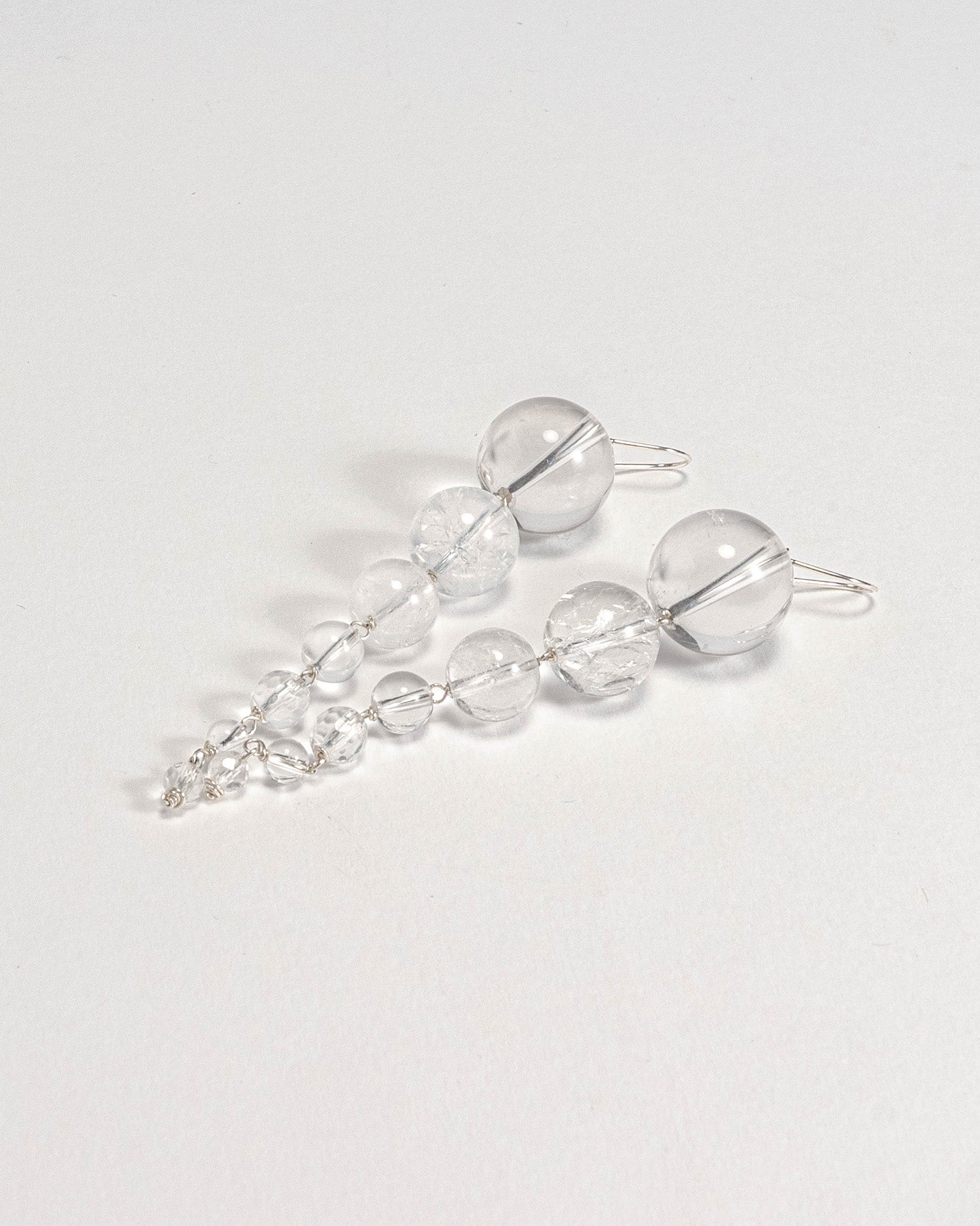 Elegant quartz beaded earrings with unique clear quartz stones and silver hooks, 8 cm in length, radiating subtle luxury.