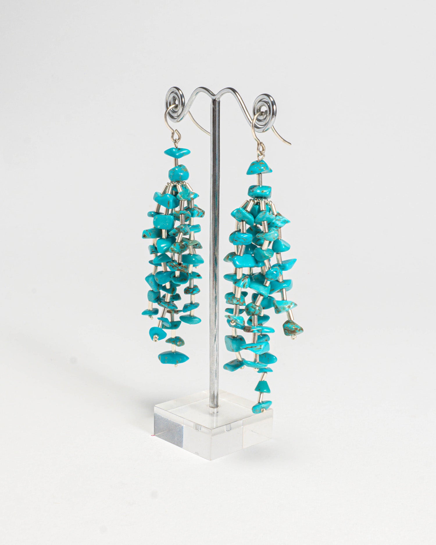 Turquoise stone fringe earrings featuring vibrant turquoise stones with silver hooks, 9 cm in length, offering a long and elegant design.