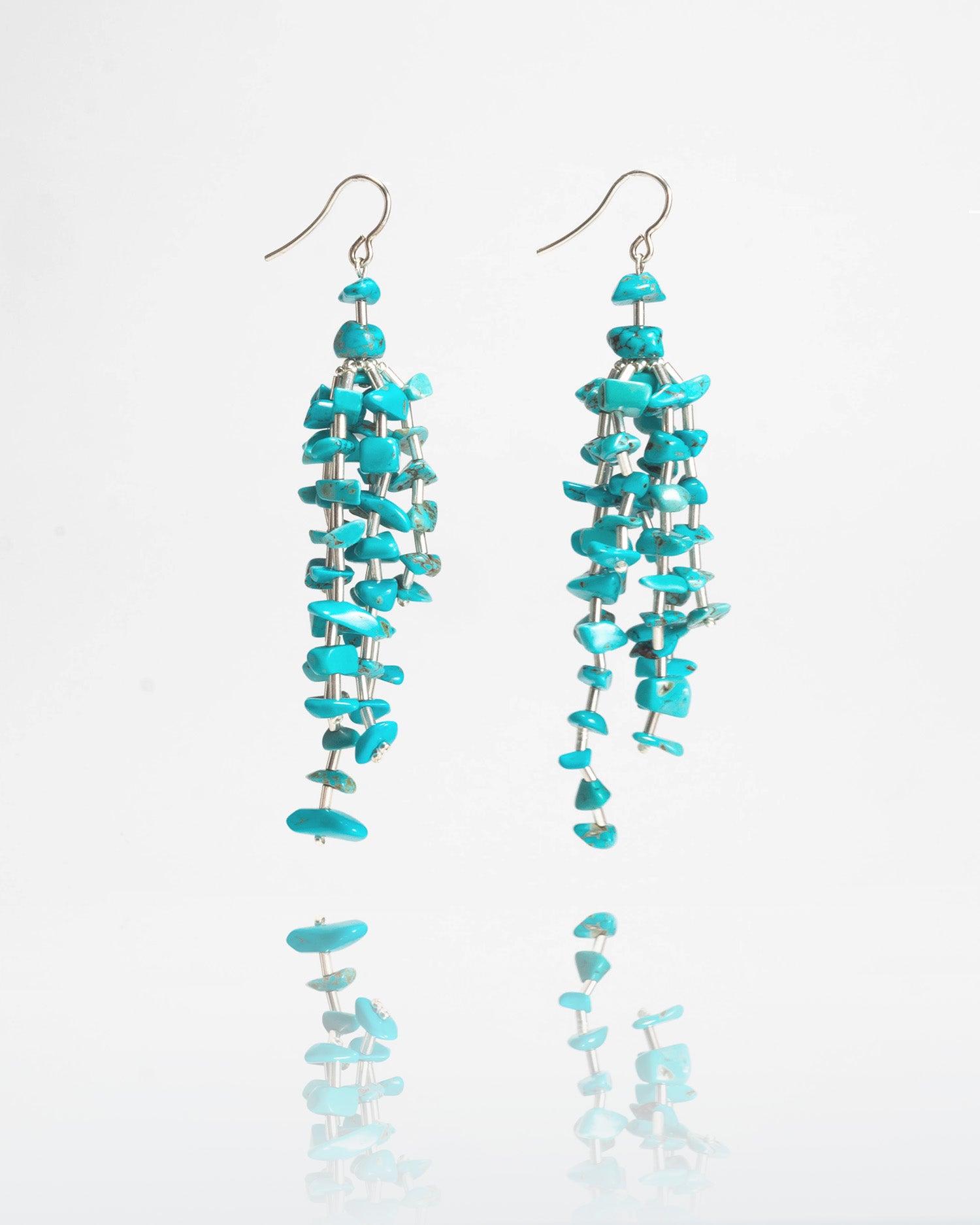 Turquoise stone fringe earrings featuring vibrant turquoise stones with silver hooks, 9 cm in length, offering a long and elegant design.