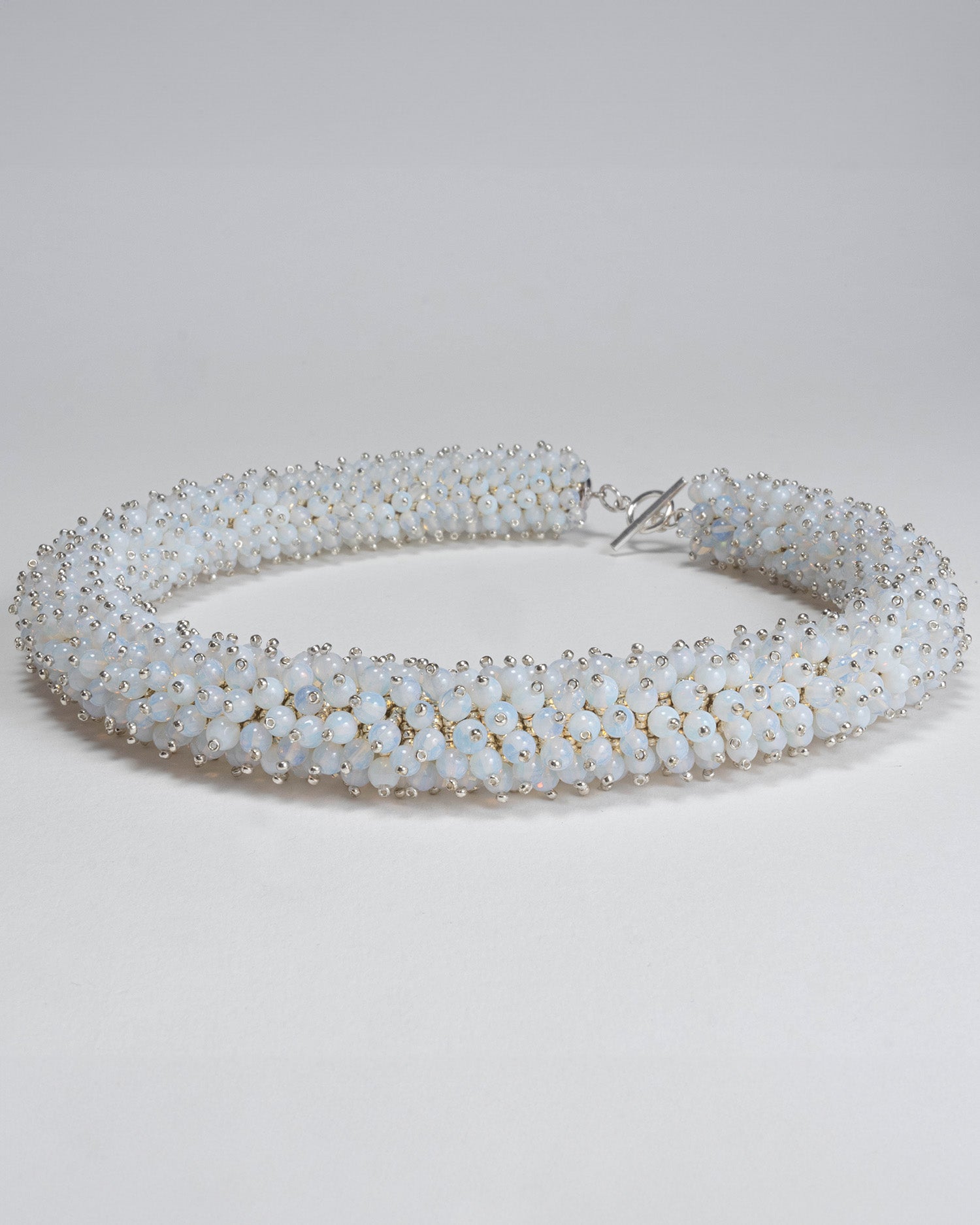 Radiant opalite necklace featuring opalescent beads in a bold rope design with a silver T-bar clasp, 45 cm in length, perfect for haute couture styling.