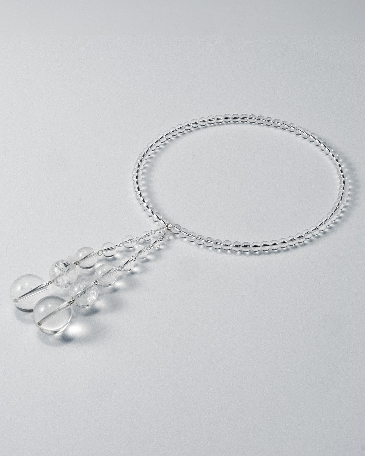 Quartz open choker featuring transparent quartz beads and silver accents, with an adaptable design for timeless elegance.