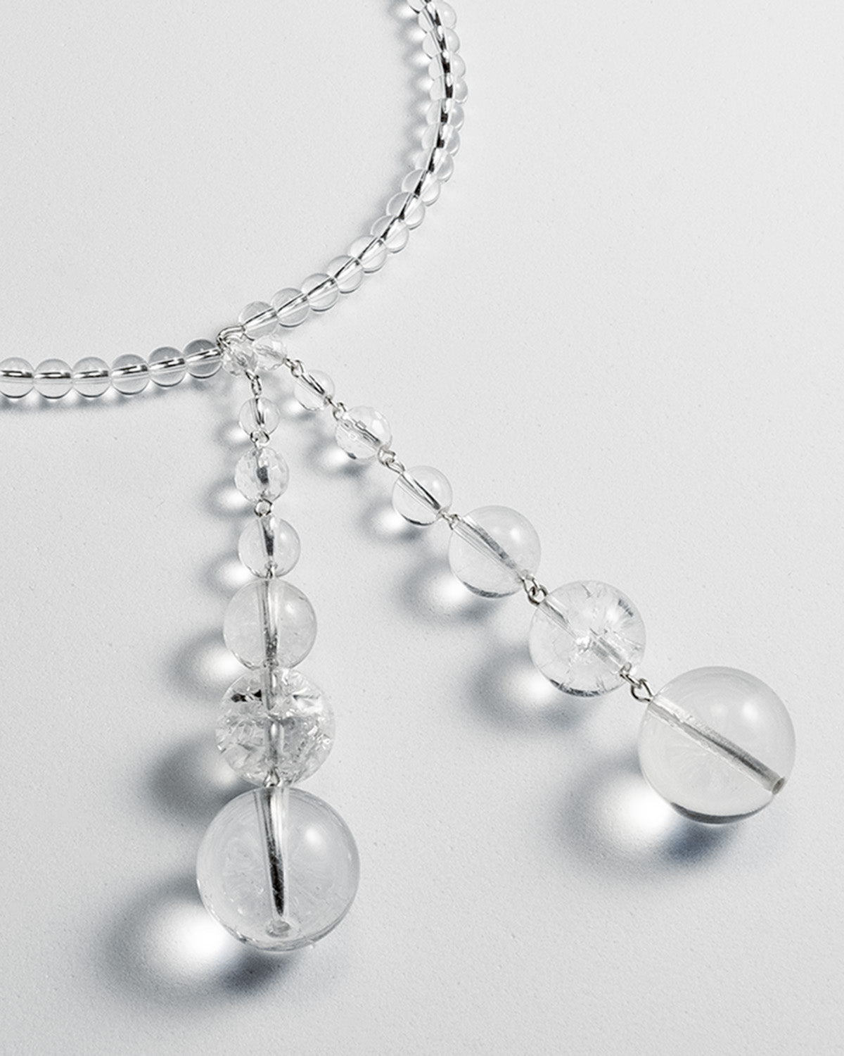 Quartz open choker featuring transparent quartz beads and silver accents, with an adaptable design for timeless elegance.