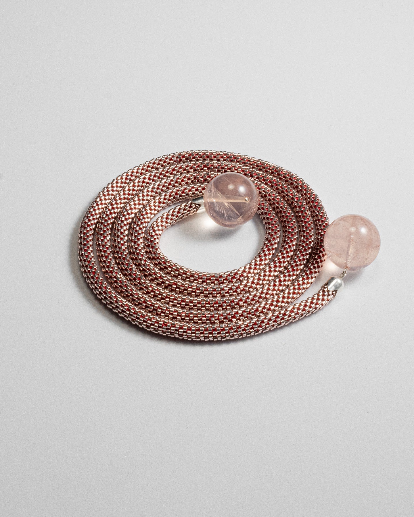 Elegant mono-strand necklace featuring Rose Quartz spheres and a Japanese beaded crochet rope, 106 cm in length.