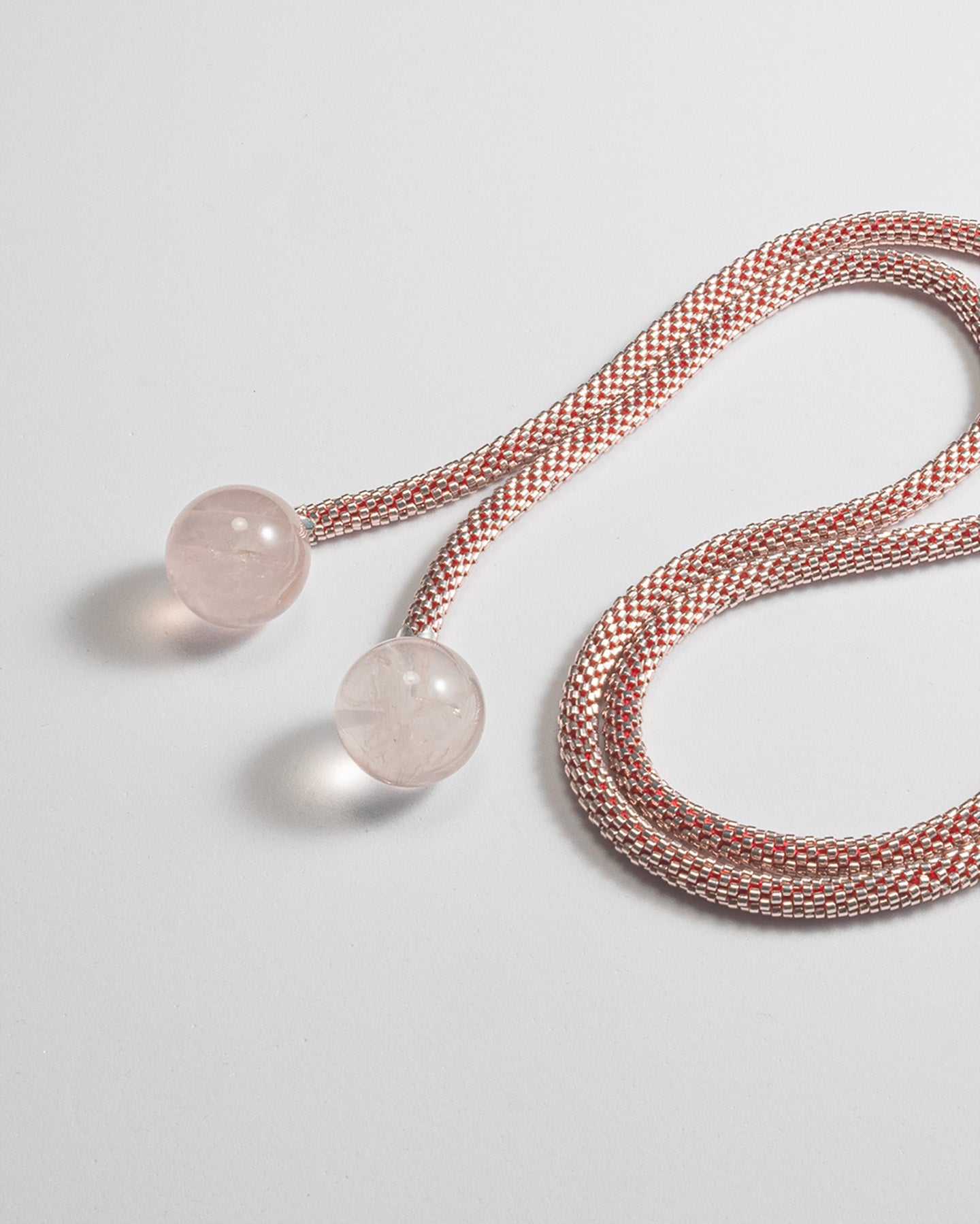 Elegant mono-strand necklace featuring Rose Quartz spheres and a Japanese beaded crochet rope, 106 cm in length.