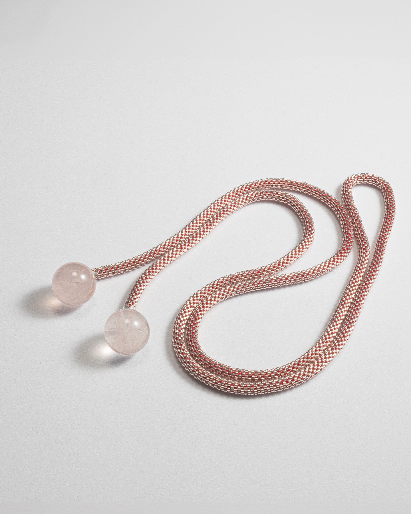 Elegant mono-strand necklace featuring Rose Quartz spheres and a Japanese beaded crochet rope, 106 cm in length.