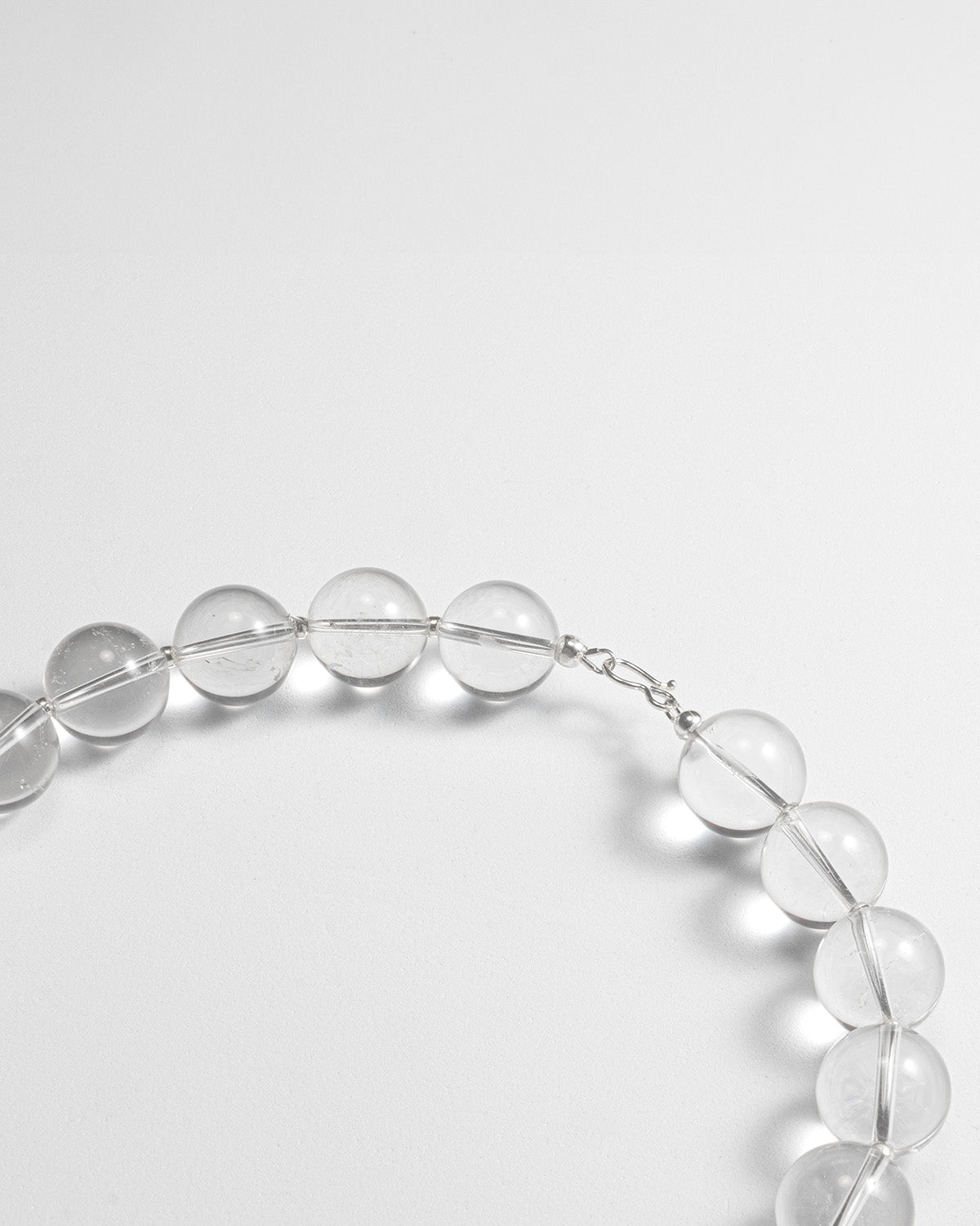 Quartz big beads short necklace featuring transparent quartz gemstones with a stainless steel clasp, 45 cm in length, offering a timeless and elegant design.