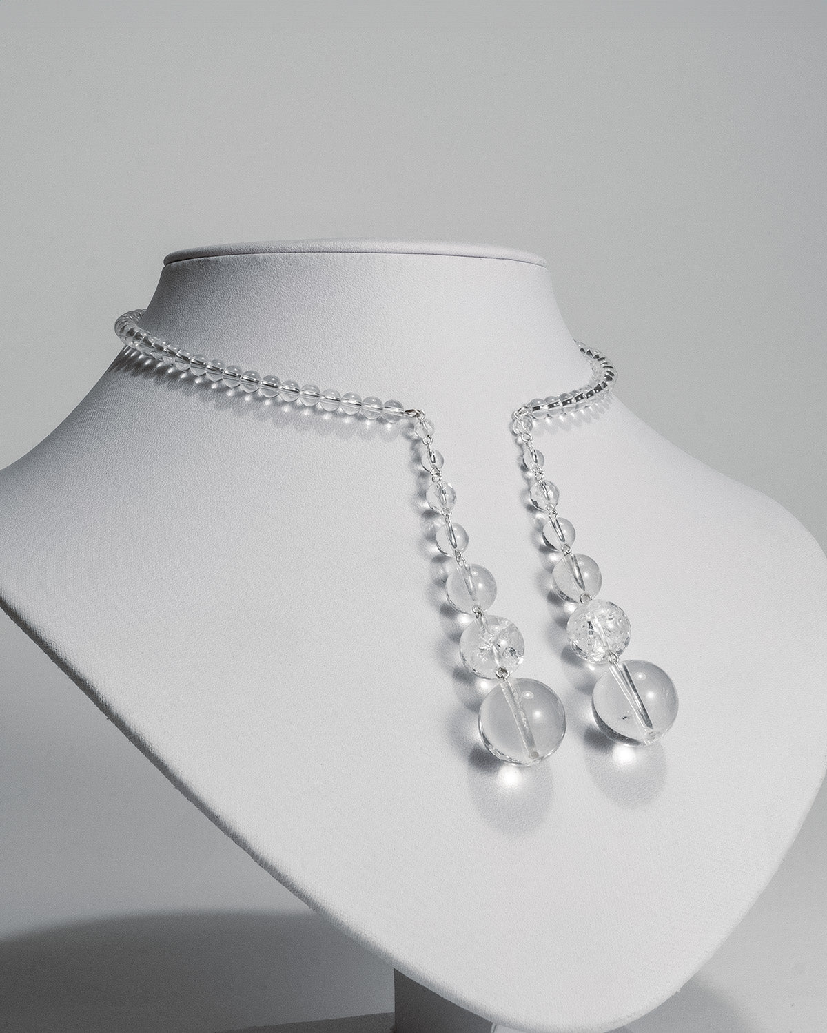 Quartz open choker featuring transparent quartz beads and silver accents, with an adaptable design for timeless elegance.