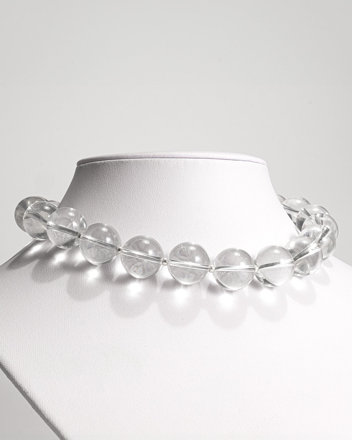 Quartz big beads short necklace featuring transparent quartz gemstones with a stainless steel clasp, 45 cm in length, offering a timeless and elegant design.