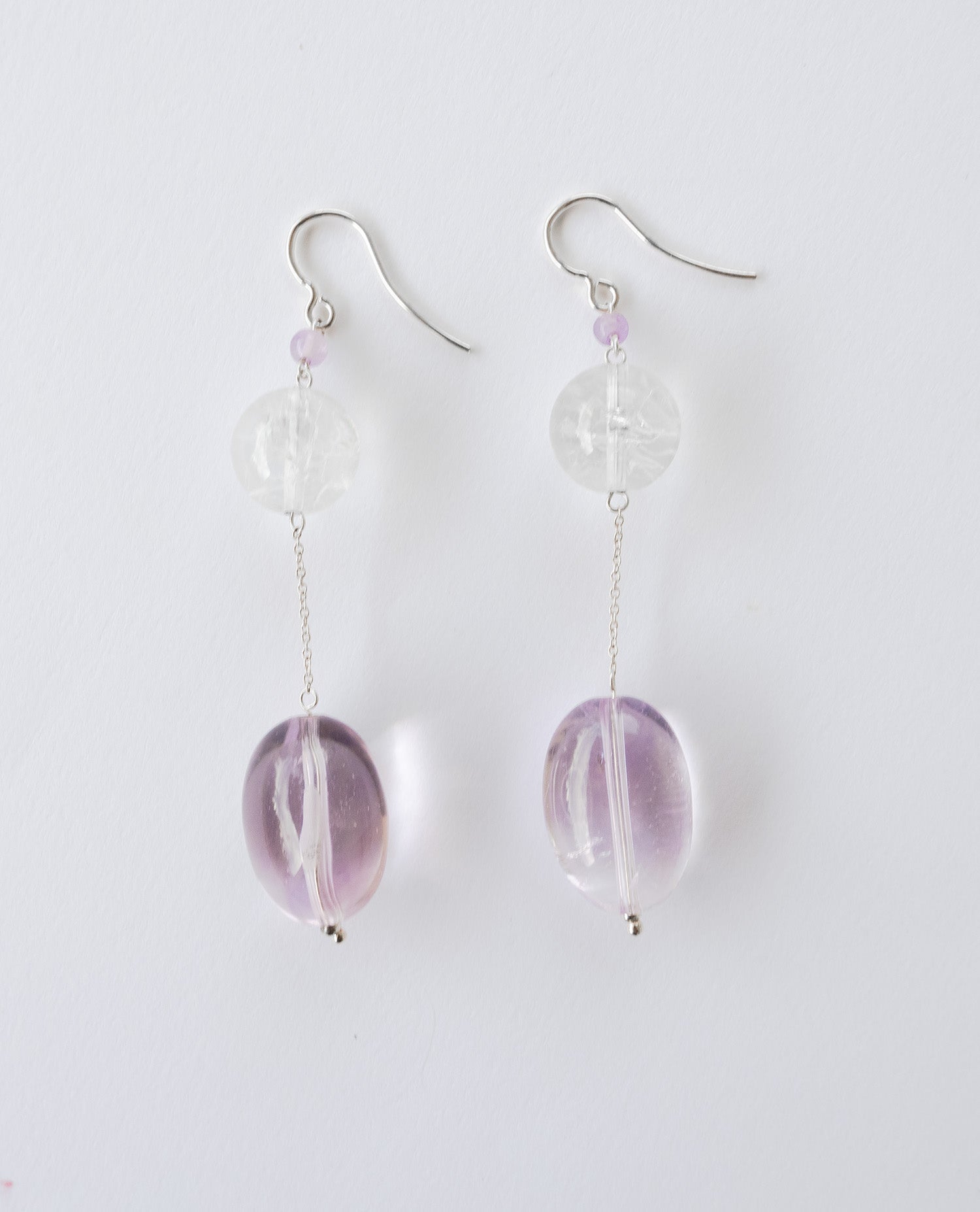 Elegant chain earrings featuring shimmering Crackle Quartz and a deep purple oval Amethyst stone, suspended from silver chains with hooks.