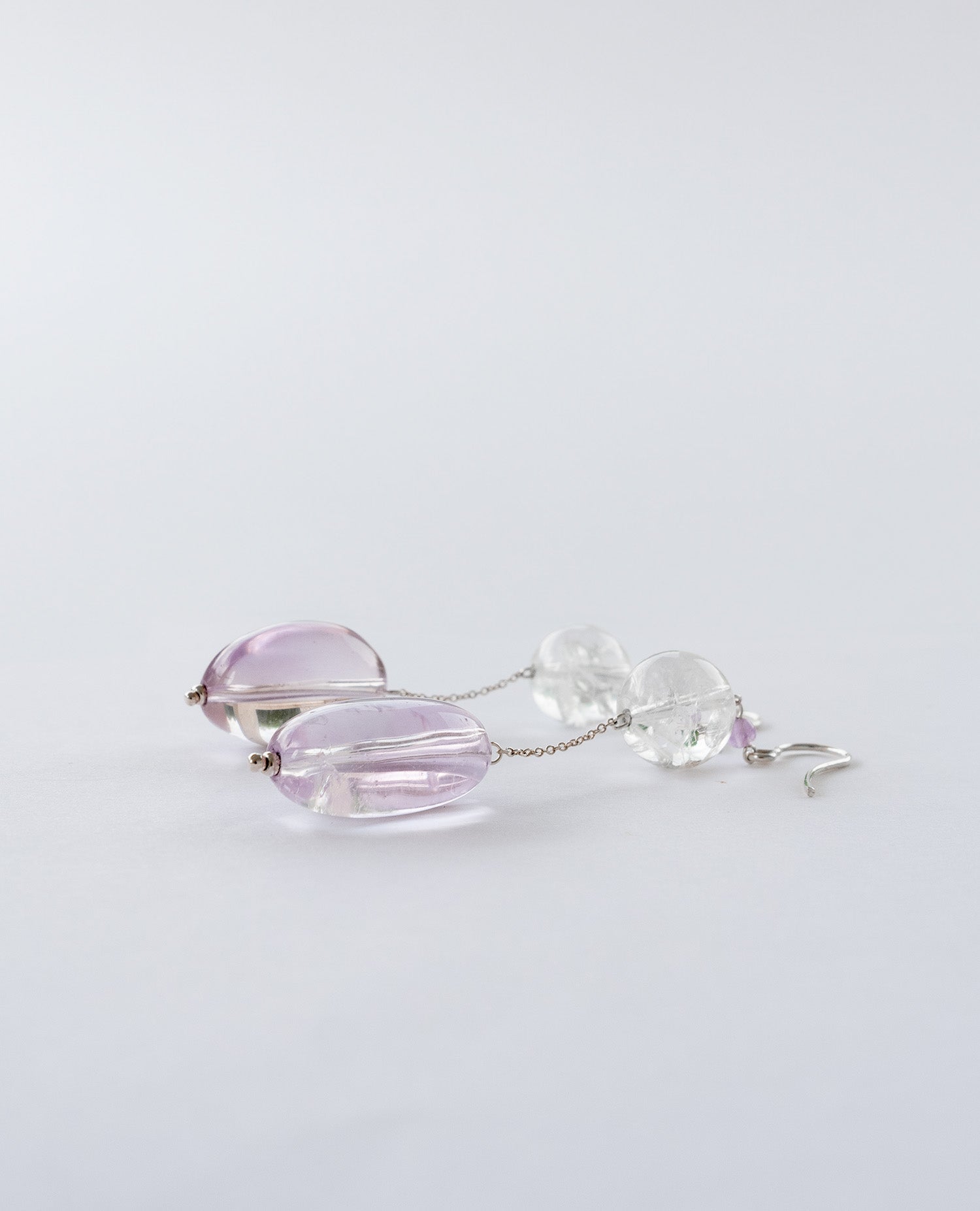 Elegant chain earrings featuring shimmering Crackle Quartz and a deep purple oval Amethyst stone, suspended from silver chains with hooks.