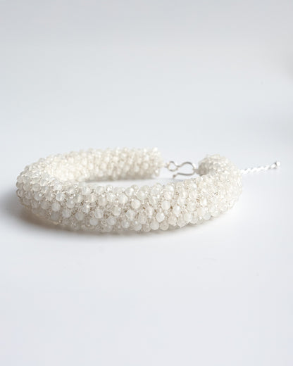 Delicate bracelet crafted from shimmering moonstone beads with a silver clasp and adjustable chain extender, 19 cm in length.