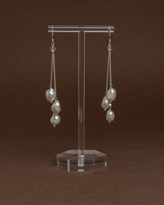 Cascade earrings with sterling silver chains and large baroque pearls. Unique handmade jewelry perfect for bridal wear or minimalist luxury looks.
