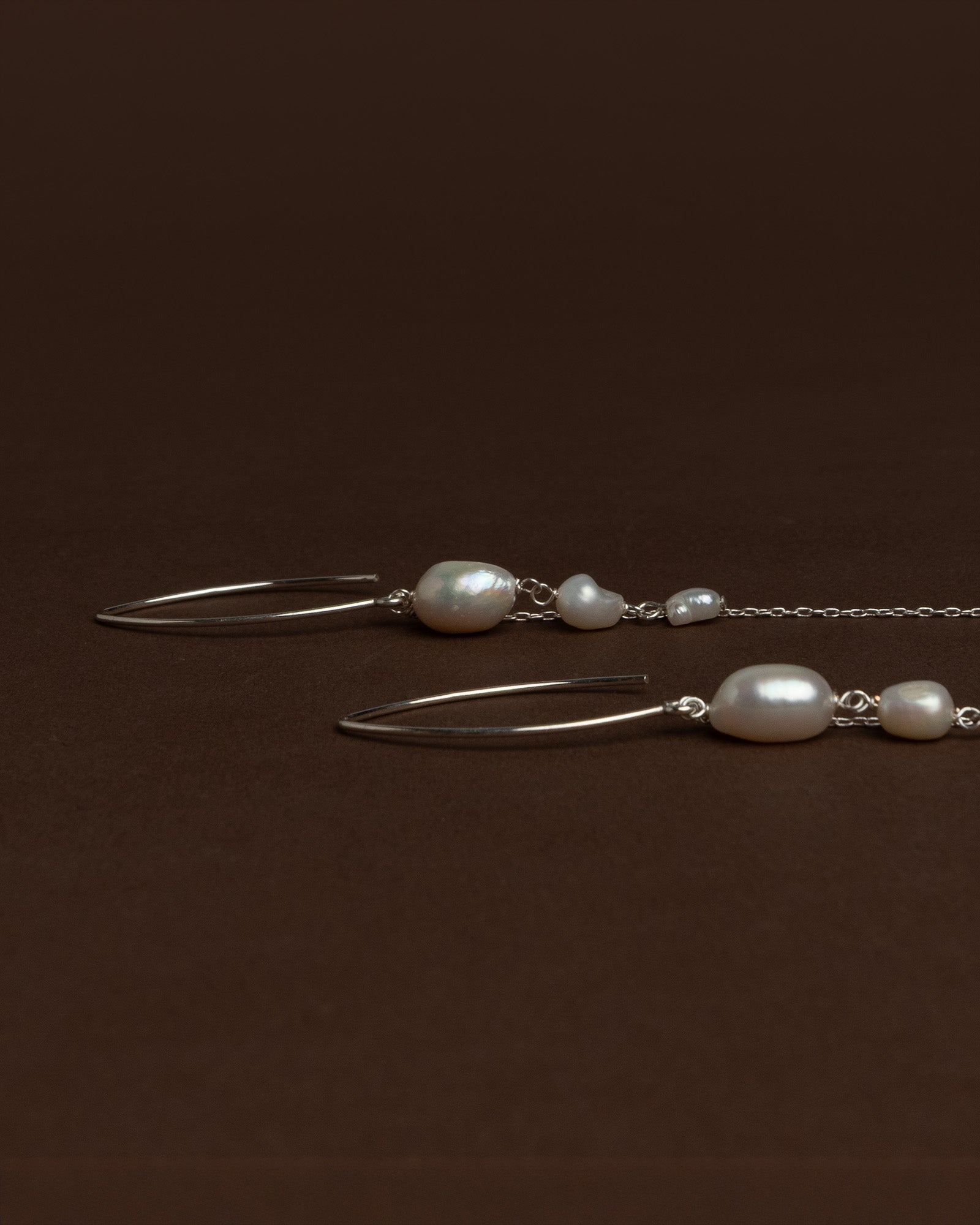 Elegant long earrings with baroque freshwater pearls and silver chains. Handmade and unique, ideal for brides and special occasions.