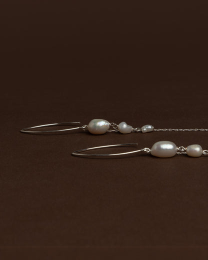 Elegant long earrings with baroque freshwater pearls and silver chains. Handmade and unique, ideal for brides and special occasions.