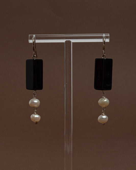 Minimalist earrings with baroque pearls and black agate. Handmade sterling silver drop earrings for modern elegance and everyday sophistication.