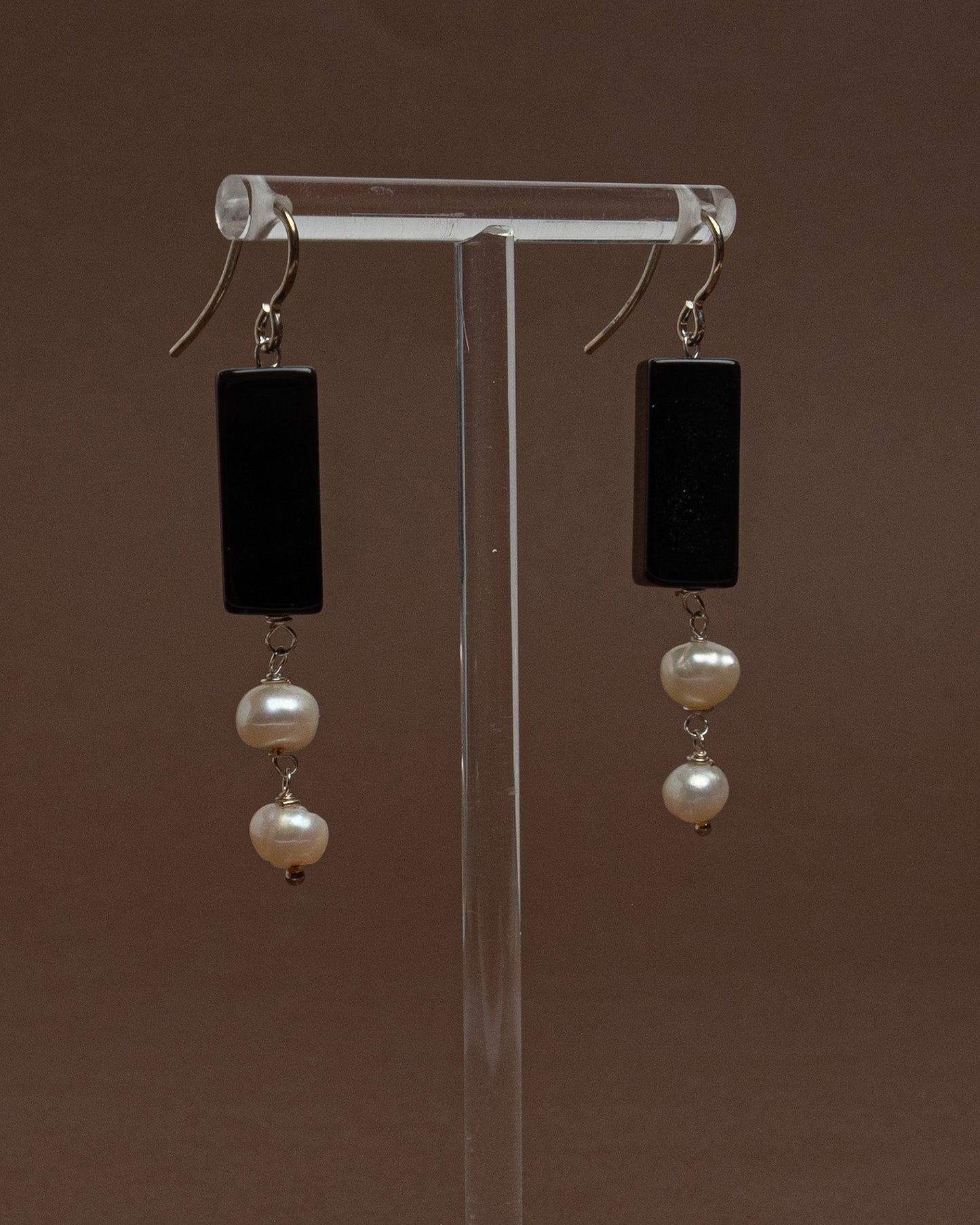 Minimalist earrings with baroque pearls and black agate. Handmade sterling silver drop earrings for modern elegance and everyday sophistication.