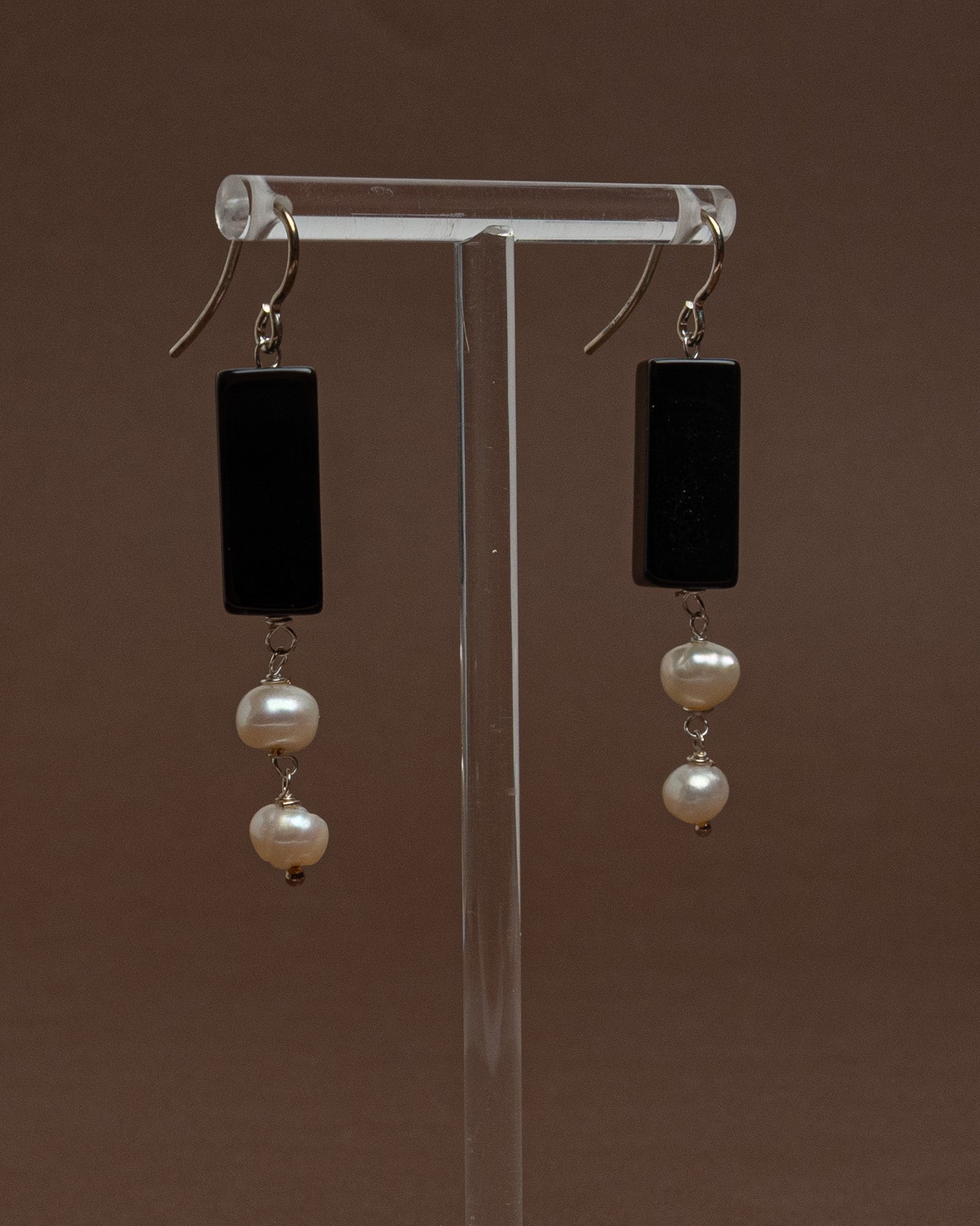 Minimalist earrings with baroque pearls and black agate. Handmade sterling silver drop earrings for modern elegance and everyday sophistication.