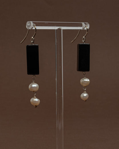 Minimalist earrings with baroque pearls and black agate. Handmade sterling silver drop earrings for modern elegance and everyday sophistication.