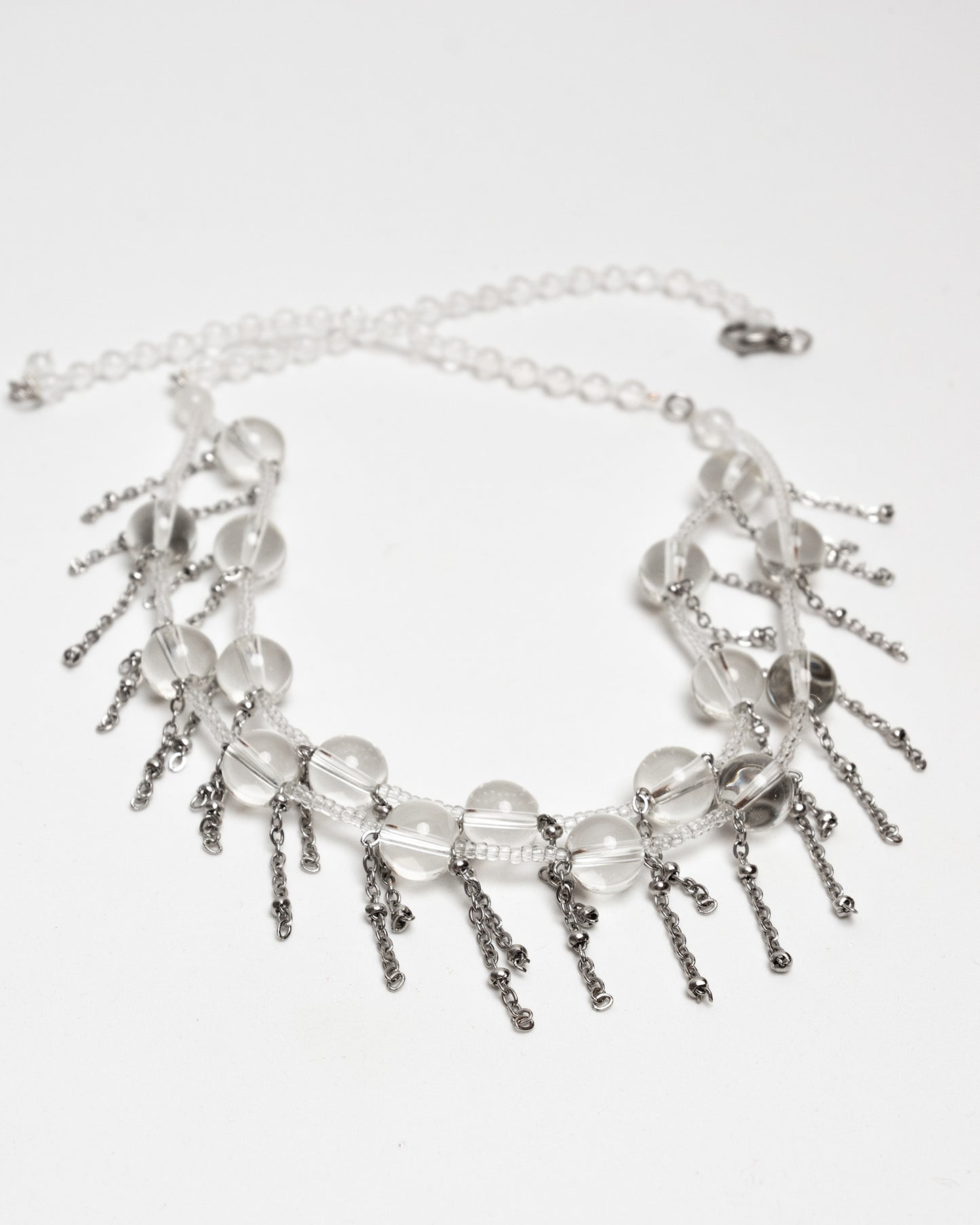 Collar de cuarzo de alta pureza con cadenas de acero inoxidable. Diseño artesanal único y moderno.