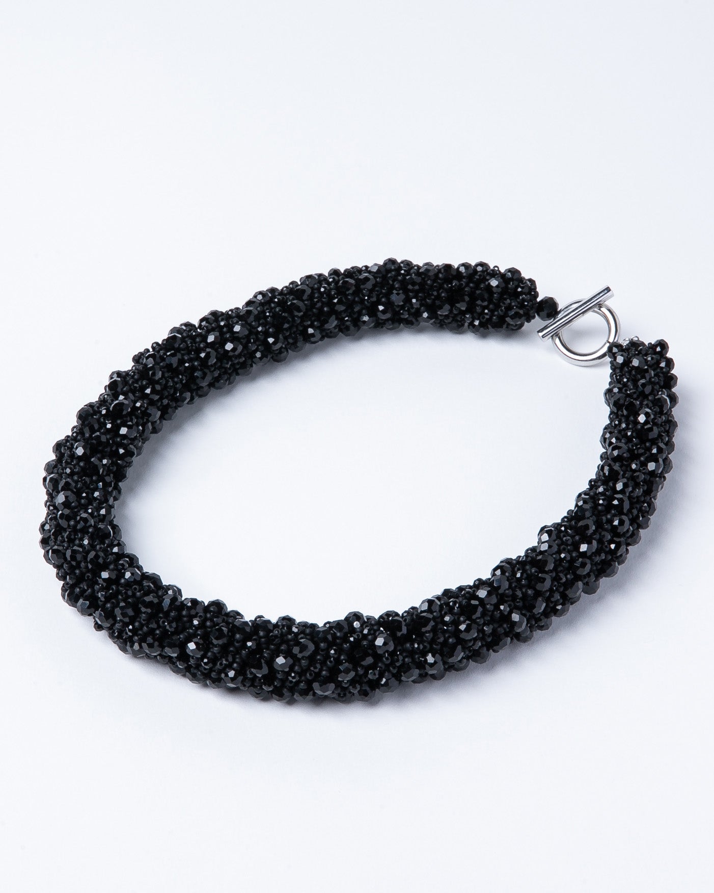 Necklace of black crystals with Japanese seed beads and a stainless steel T-clasp, 52 cm long, designed for versatile styling.