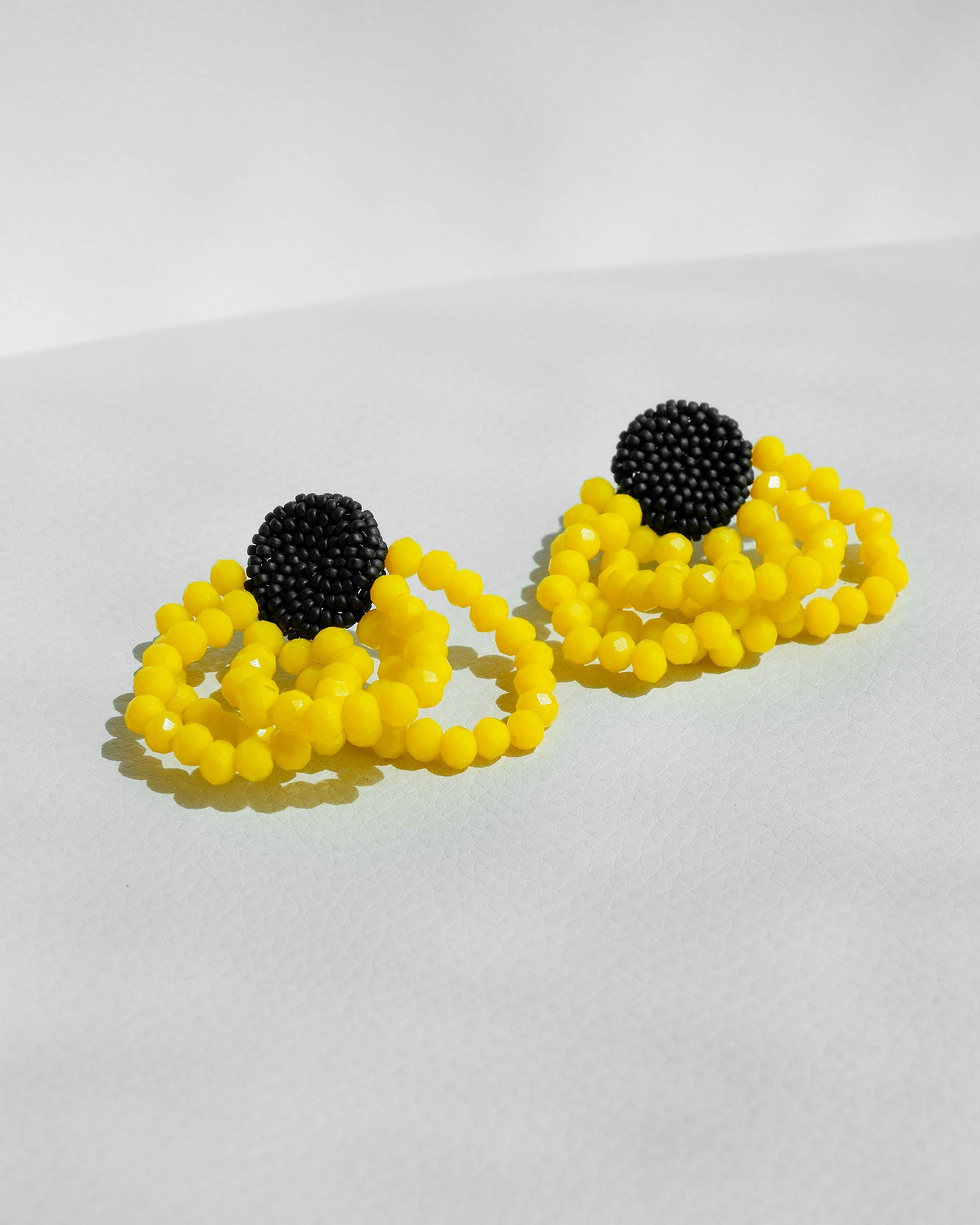 Summer style yellow earrings featuring sunny crystals and Japanese seed beads with silver studs, 5 cm in length, perfect for vibrant seasonal looks.