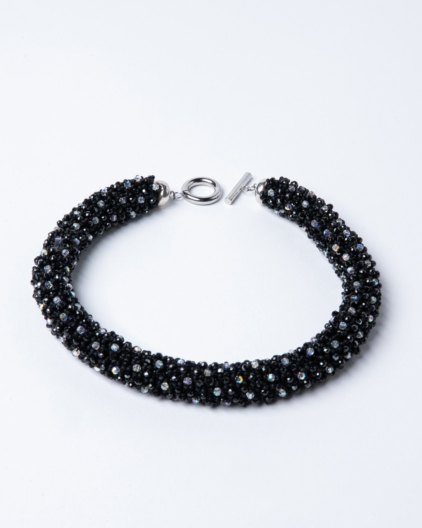 Spinel and crystals necklace featuring deep black spinel stones and shimmering crystals with a stainless steel T-bar clasp, 45 cm in length, offering bold elegance.