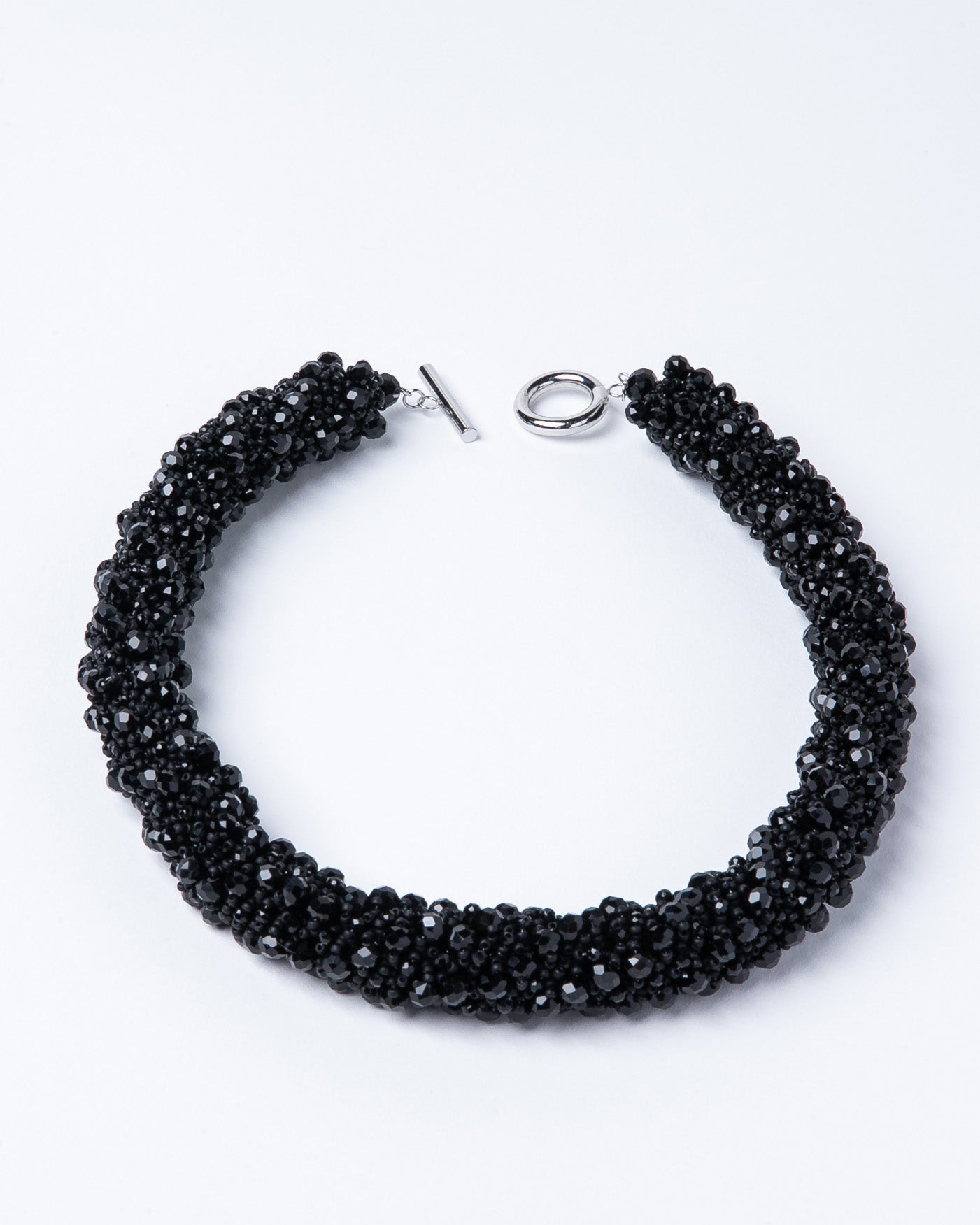 Necklace of black crystals with Japanese seed beads and a stainless steel T-clasp, 52 cm long, designed for versatile styling.