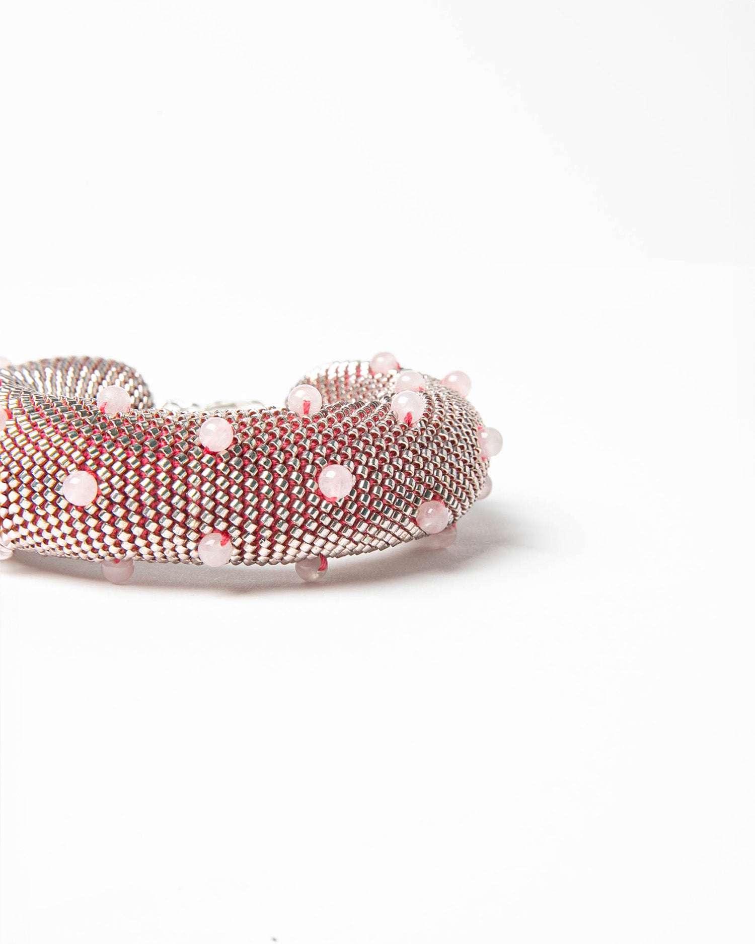 Luminous bracelet crafted with jewelry seed beads and rose quartz stones, featuring a silver clasp, custom-fitted for perfect comfort and elegance.