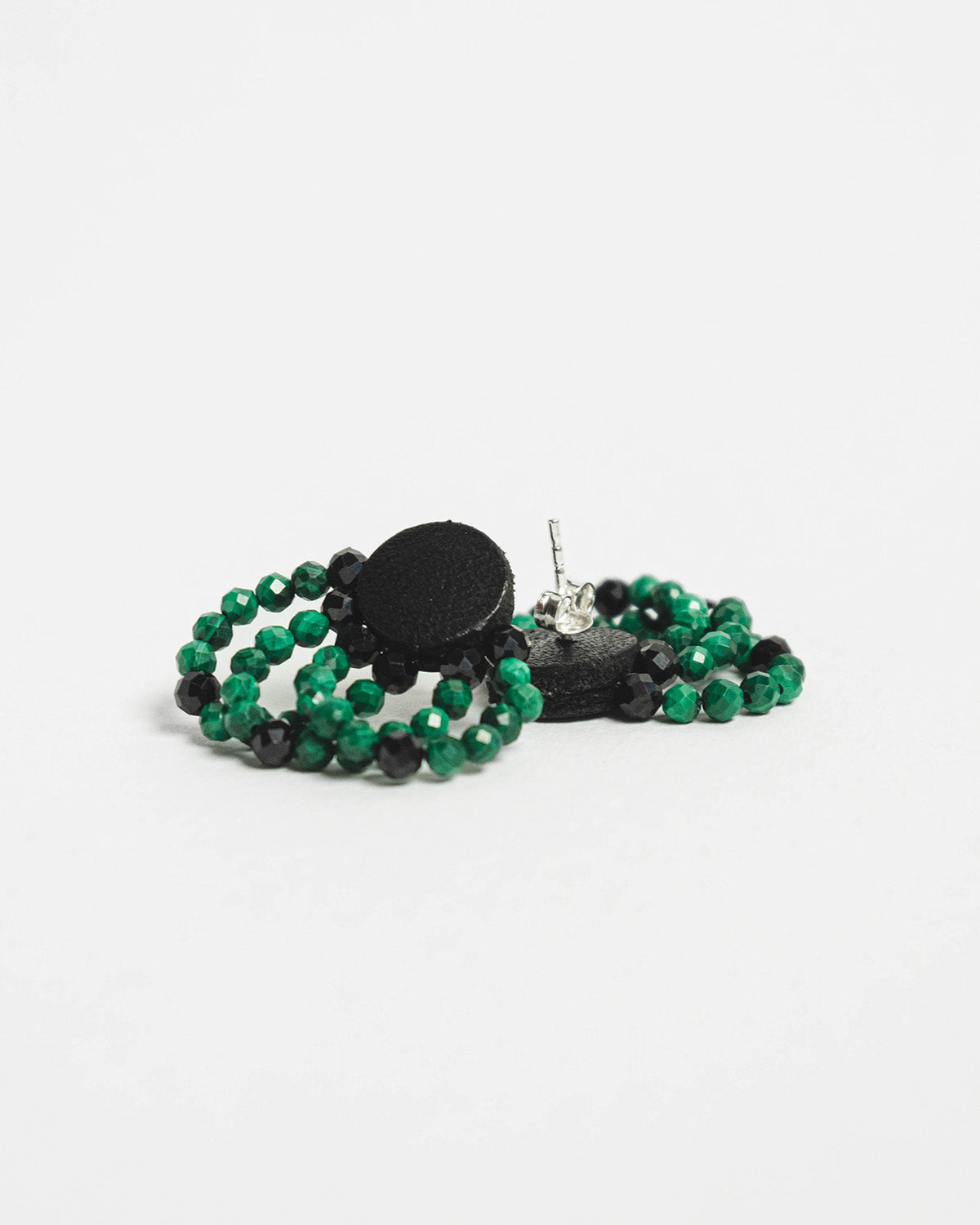 Malachite bead and leather earrings with silver studs, 2 cm in length, offering a bold and modern design.